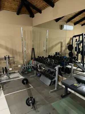 a gym with lots of equipment in a room at 1 Bedroom with pool and walking distance to beach in Tamarindo