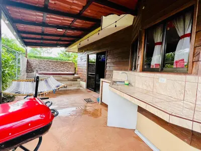 a garage with a red car parked in it at Cabañas del Norte in Fortuna