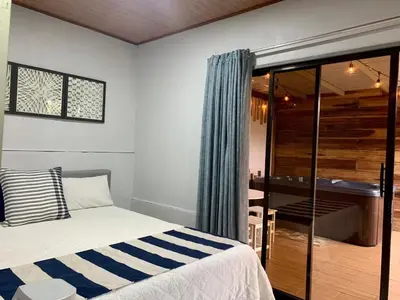 a bedroom with a bed and a desk in a room at Cabañas del Norte in Fortuna