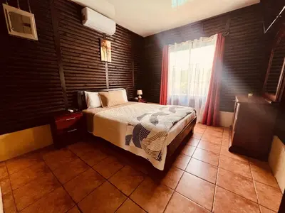 a bedroom with a large bed and a window at Cabañas del Norte in Fortuna
