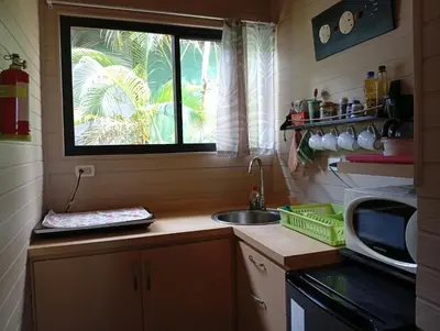 a small kitchen with a sink and a window at Eden Tica Lodge in Uvita