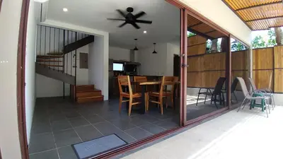 a dining room and living room with a ceiling fan at Green Turtle Townhome #1 Private Pool & Garden 300 Mtrs to Beach in Tamarindo