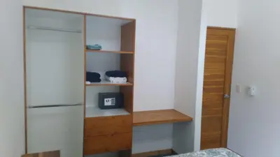 a room with a glass cabinet and a door at Green Turtle Townhome #1 Private Pool & Garden 300 Mtrs to Beach in Tamarindo