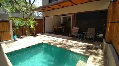 a swimming pool in front of a house with a patio at Green Turtle Townhome #1 Private Pool & Garden 300 Mtrs to Beach in Tamarindo
