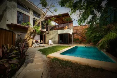 a swimming pool in the backyard of a house at New Beach House Walk to Tamarindo Beach & Town in Tamarindo