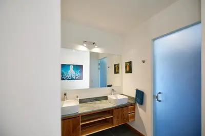 a bathroom with two sinks and a large mirror at New Beach House Walk to Tamarindo Beach & Town in Tamarindo