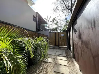 a walkway in a house with a fence and plants at 1Bedroom Apt wPool Walk to beach in Tamarindo