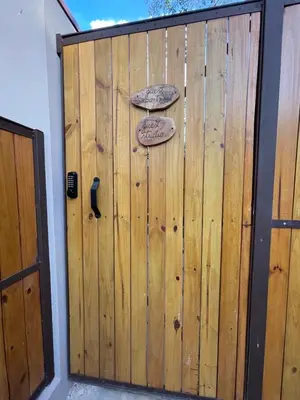 a wooden garage door with two signs on it at Guest Studio Apt Pool 300m beach in Tamarindo