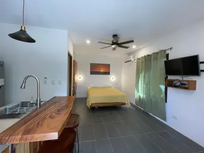 a kitchen with a sink and a bed in a room at Guest Studio Apt Pool 300m beach in Tamarindo