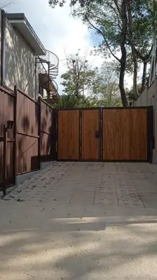 a driveway with a wooden gate and a fence at Guest Studio Apt Pool 300m beach in Tamarindo
