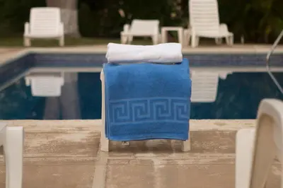 a blue towel sitting next to a swimming pool at Hotel & Villas Tangerí in Jacó