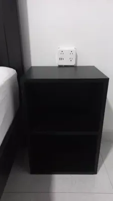 a black dresser with a white alarm clock on it at Casa Bahía Ale, Bahía Ballena Uvita in Uvita