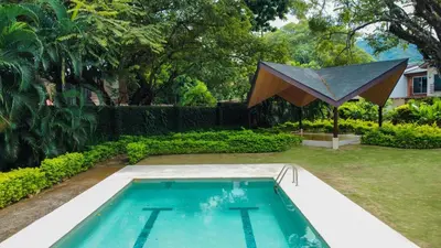 a swimming pool in the yard of a house at Amazing home with private pool & high-speed Wi-Fi! in Jacó