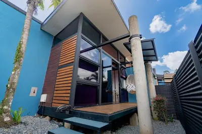 a house with a large window and some stairs at Olly´s House in Turrialba