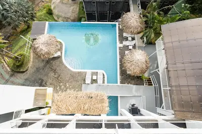 an overhead view of a swimming pool in a house at El Faro Containers Beach Hotel in Manuel Antonio