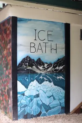 a painting on a wall with the words ice bath at Jungles Edge Hotel, Jiu Jitsu, Muay Thai Retreat Center in Nosara