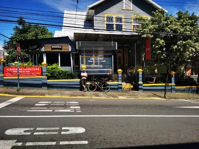 a man standing in front of a store on a street at Casa Aldea Hotel Bed & Breakfast in San José