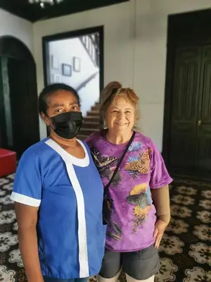 a man wearing a mask standing next to a woman at Casa Aldea Hotel Bed & Breakfast in San José