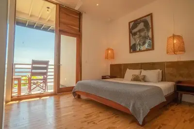 a bedroom with a bed with a view of the ocean at Outsite Santa Teresa Maramar in Puntarenas