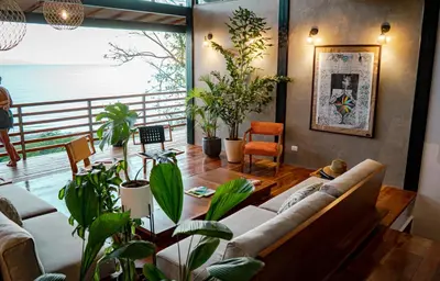 a living room with a couch and some plants at Outsite Santa Teresa Maramar in Puntarenas