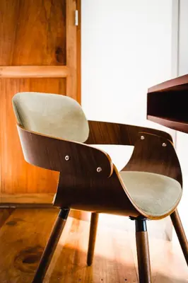 a wooden chair sitting in front of a table at Outsite Santa Teresa Maramar in Puntarenas