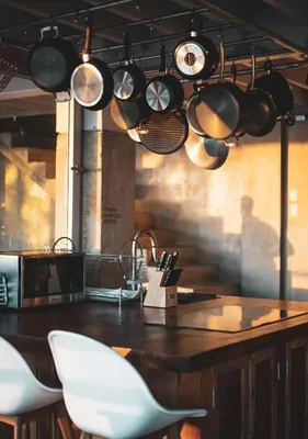 a kitchen with pots and pans hanging from the ceiling at Outsite Santa Teresa Maramar in Puntarenas