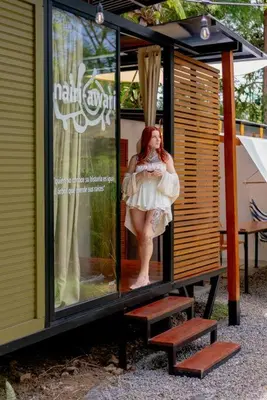 a woman is standing inside of a house at Tiny garden house in Turrialba