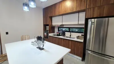 a kitchen with a white counter and a refrigerator at Casa Santa Fe Arenal Volcano in Fortuna