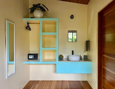 a bathroom with a blue shelf and a sink at ChicoRico Studios in Uvita