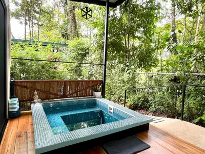 a swimming pool in the middle of a patio at ChicoRico Studios in Uvita