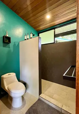 a bathroom with a toilet and a sink at ChicoRico Studios in Uvita