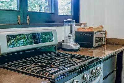 a kitchen stove with a blender on top of it at Makara Resort 5 Bedrooms in Uvita