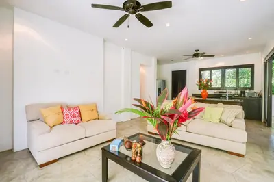 a living room with two couches and a table at Makara Resort 5 Bedrooms in Uvita