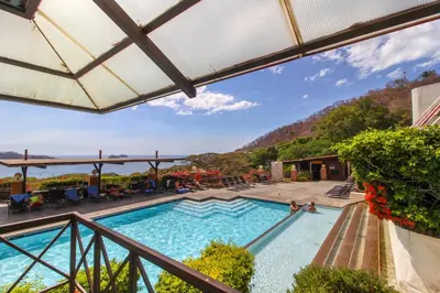 a view of a swimming pool from a balcony at Villa Sol 35 & 36 in Playa Hermosa