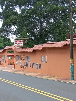 a building with a sign for a hotel la uvita at Hotel La Uvita in Puerto Limón