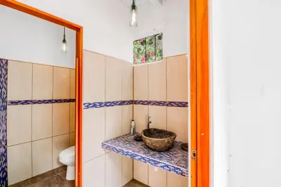 a bathroom with a sink and a toilet at Lost Pools Bungalows in Ojochal