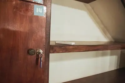 a door with a remote control sitting on a shelf at Mai Ke Kai Surf House in Tamarindo