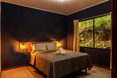 a bedroom with a bed with a window at Finca Murillo in Monteverde Costa Rica