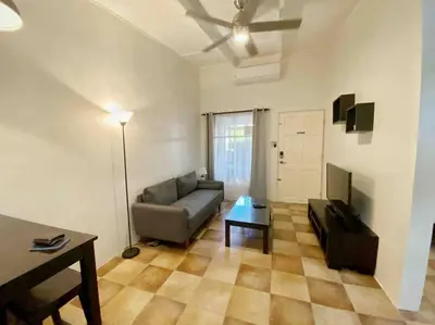 a living room with a couch and a table at Beach Bliss - 1BR Villa with Pool 2 blocks from ocean in Jacó