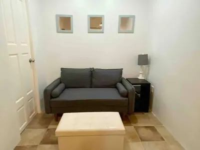 a living room with a couch and a table at Beach Bliss - 1BR Villa with Pool 2 blocks from ocean in Jacó