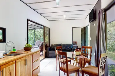 a kitchen and dining room with a table and chairs at Aqua Tarrazu in Santa Cruz