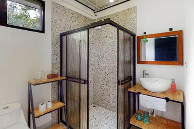 a bathroom with a shower and a sink at Aqua Tarrazu in Santa Cruz