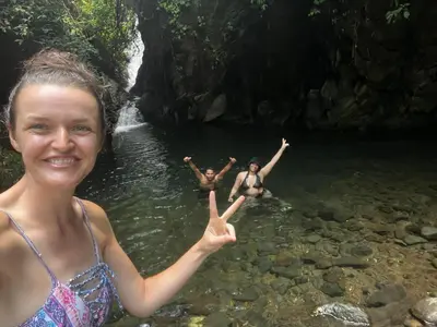 a woman in the water with a peace sign at Granja Integral Luz Del Corazon in Rincón de la Cruz