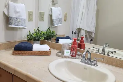 a bathroom counter with a sink and a mirror at Casita Del Mar in Herradura