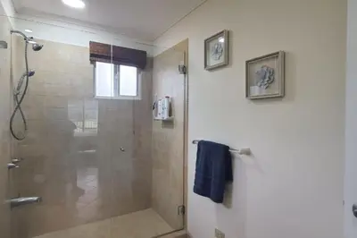 a bathroom with a shower with a glass door at Casita Del Mar in Herradura