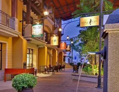 an empty street with tables and chairs in a building at Casita Del Mar in Herradura