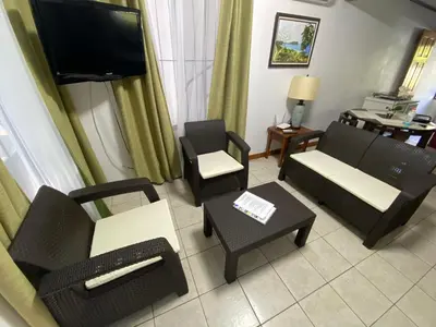 a living room with furniture and a flat screen tv at Apto Cielo Azul in Manuel Antonio