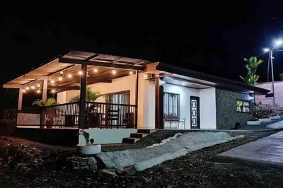a small house with a balcony at night at Villa Ali Río Cuarto in Río Cuarto