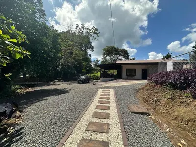 a house with a gravel road in front of a house at Villa Ali Río Cuarto in Río Cuarto