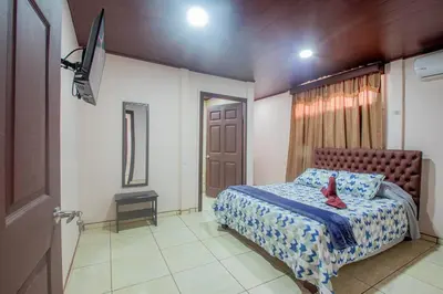 a bedroom with a bed with a red shoe on it at Villa Ali Río Cuarto in Río Cuarto